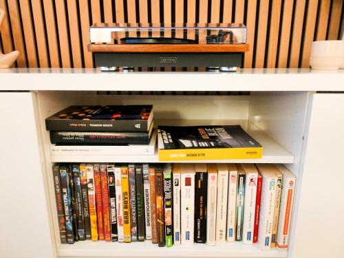 a book shelf filled with lots of books at Escapade au cœur de Luce chartres in Luce