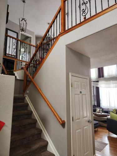 een trap in een huis met een witte deur bij private bedroom in beautiful large home in Firestone