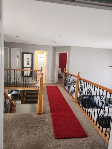 een trap met een rode loper en een rode deken bij private bedroom in beautiful large home in Firestone