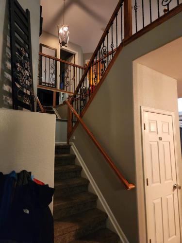 een trap in een huis met een witte deur bij private bedroom in beautiful large home in Firestone