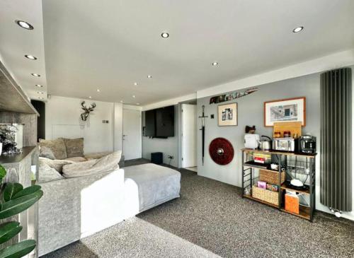 a living room with a white couch in a room at Priest Royd Nook - Luxury Lodgings 