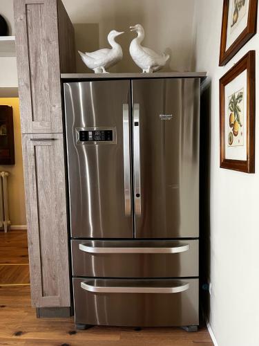 a refrigerator with two birds on top of it at Maestra Exclusive Chianti House, Tuscany in Poggibonsi