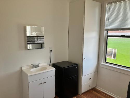 a small bathroom with a sink and a window at 1080 Folsom Residences in San Francisco