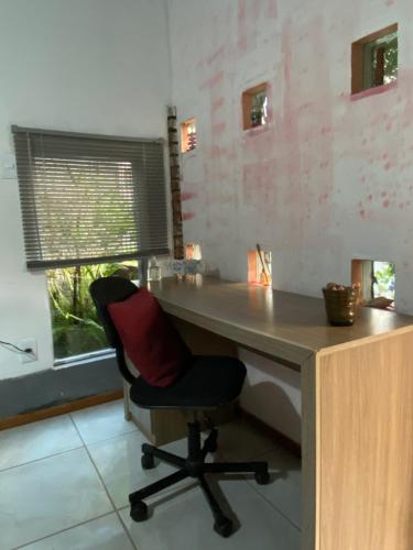 a desk with a chair in a room at Espaço privativo, funcional e aconchegante in Santana do Livramento