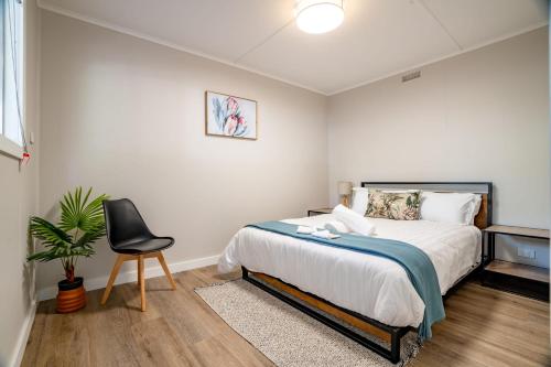 a bedroom with a bed and a chair in it at The Wannon 2 in Dadswells Bridge