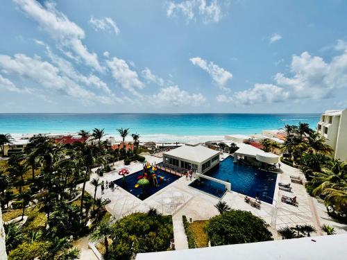 an aerial view of a resort with a pool and the ocean at Solymar condos on the beach in Cancún