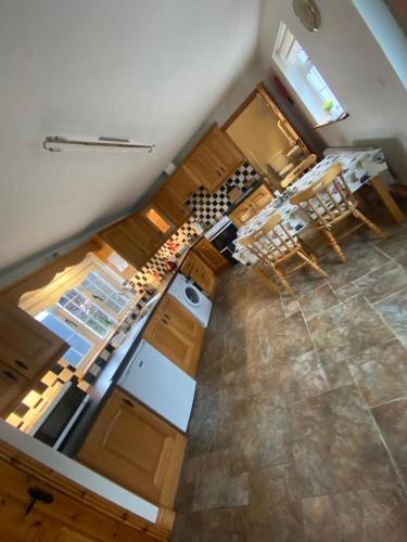an overhead view of a kitchen with wooden cabinets at Cheerful 3 bedroom country farm house in Ennis
