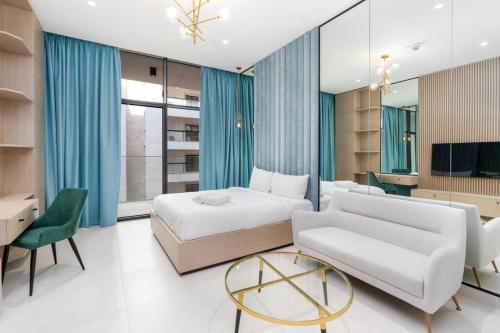 a bedroom with a bed and a couch and a table at Studio - 3min from Metro station - Westwood by Imtiaz in Dubai