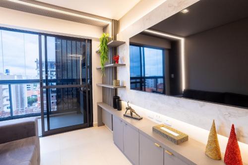 a bathroom with a counter and a large window at Park Del Prado #602 - Intermares por Carpediem in João Pessoa