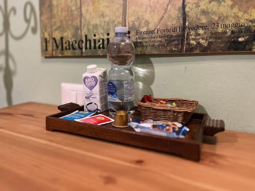 a bottle of water and a basket on a table at Albero Mago in Florence