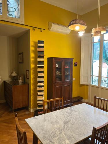 a dining room with a table and chairs and a book shelf at Albero Mago in Florence