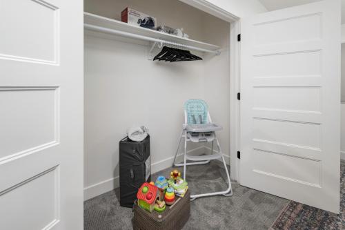 a walk in closet with a white door and a chair at Updated 2BR 1BA Flat Steps from 25th Street Fun in Ogden