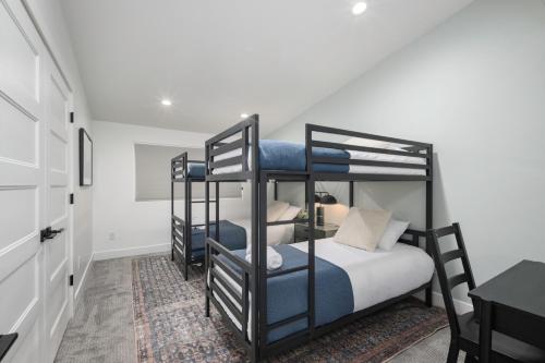 a bedroom with two bunk beds and a table at Updated 2BR 1BA Flat Steps from 25th Street Fun in Ogden