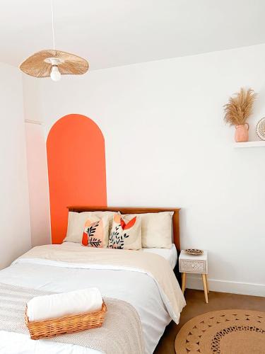 a bedroom with a bed with an orange wall at Boho Vibe Room Centrally Located in Portsmouth City in Portsmouth