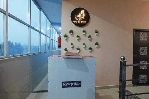 a reception area in a building with potted plants at OYO HOTEL RELAX in Ballabgarh