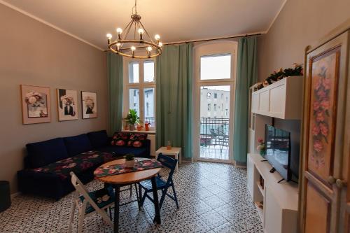 a living room with a couch and a table at Apartament u Olechny in Bydgoszcz