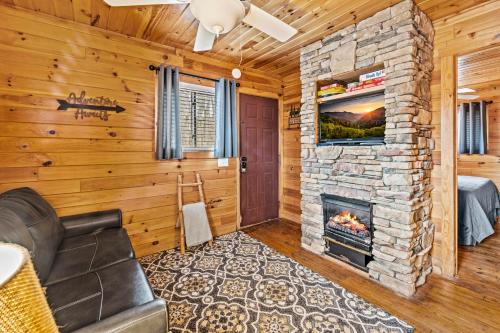 a living room with a stone fireplace at Laughing Bear Cabin 44B in Bryson City