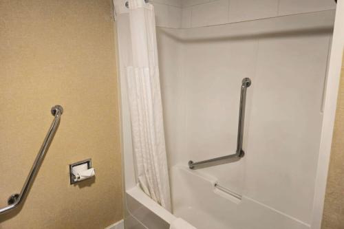 a bathroom with a shower stall with a toilet at Rodeway Inn & Suites in Kamloops