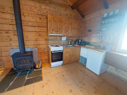 a kitchen with a stove and a stove top oven at Valen Cabins in Reine in Reine