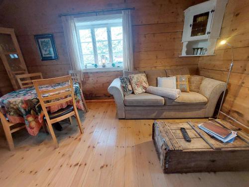 a living room with a couch and a table at Valen Cabins in Reine in Reine