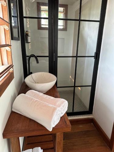 a bathroom with a sink and a glass shower at Belizima Eco Resort in Sarteneja