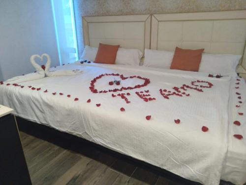a bed with a heart written on it at Mansion Azul Cholula in Cholula