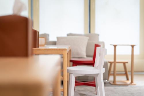 a room with a white chair and a table at 禾淞津別邸 Kashotsu Bettei in Taichung