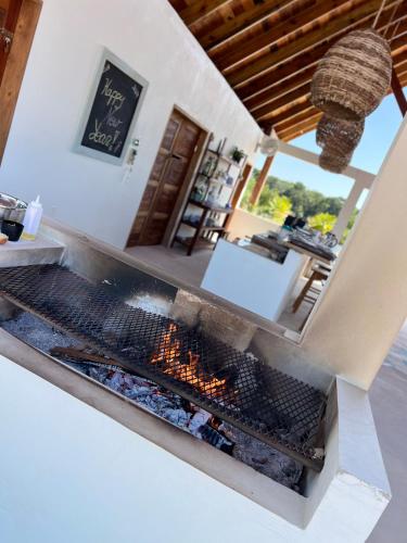 a kitchen with a grill with a fire in it at Belizima Eco Resort in Sarteneja