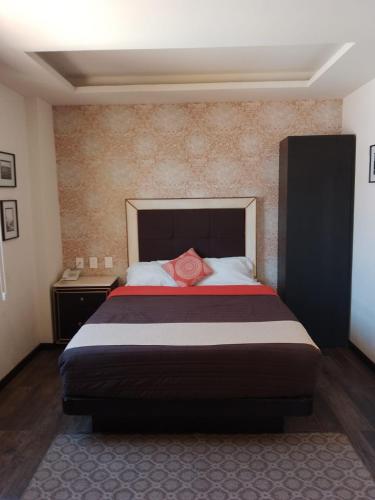 a bedroom with a bed with a red rose on it at Mansion Azul Cholula in Cholula