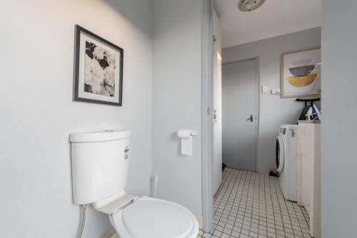 a white bathroom with a toilet and a sink at Boutique Private Room Situated in the Heart of Burwood - SHAREHOUSE in Sydney