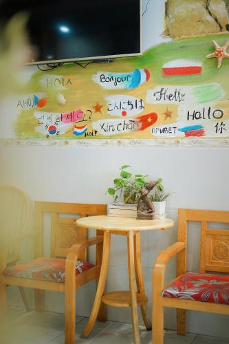 a table and two chairs and a table and a table and a table at Sông Suối Homestay in Quy Nhon