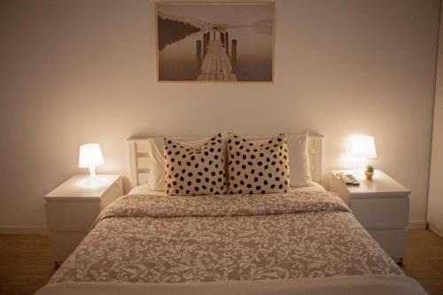 a bedroom with a large bed with two night stands at Just4uApartment - Near Lisbon & Beach - With AC in Almada
