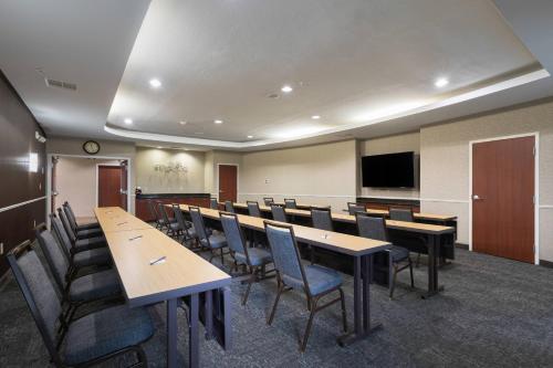 a conference room with tables and chairs and a flat screen tv at Courtyard by Marriott San Antonio North Stone Oak At Legacy in San Antonio