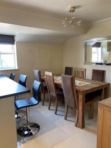ein Esszimmer mit einem Holztisch und Stühlen in der Unterkunft Mill Place in Wraysbury