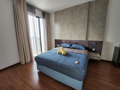 a bedroom with a bed with a teddy bear on it at Shah Alam I-City Homestay @ 2 Bedroom Apartment in Shah Alam