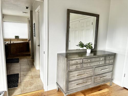 a dresser with a mirror on top of it at Fantastic Bright 4 Bedroom- Deck - Fireplaces in Medford
