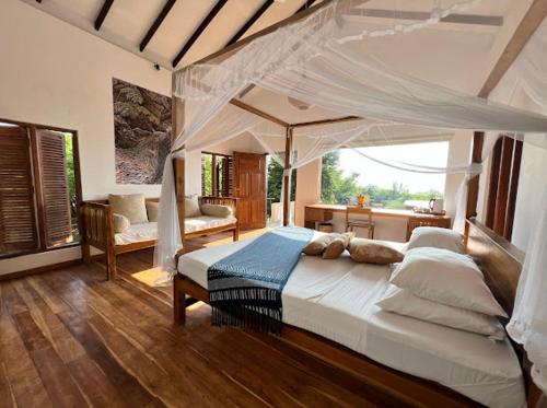 a bedroom with a large bed with a canopy at C Beyond Nilaveli in Nilaveli
