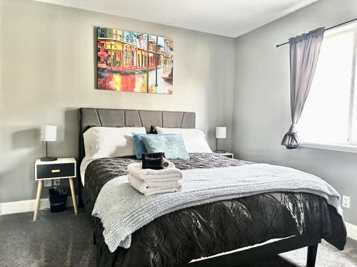 a bedroom with a bed with towels on it at Fantastic Bright 4 Bedroom- Deck - Fireplaces in Medford