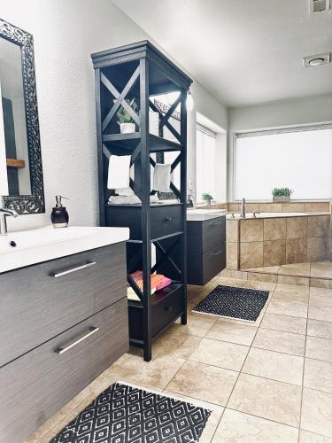 a bathroom with a black shelf next to a sink at Fantastic Bright 4 Bedroom- Deck - Fireplaces in Medford