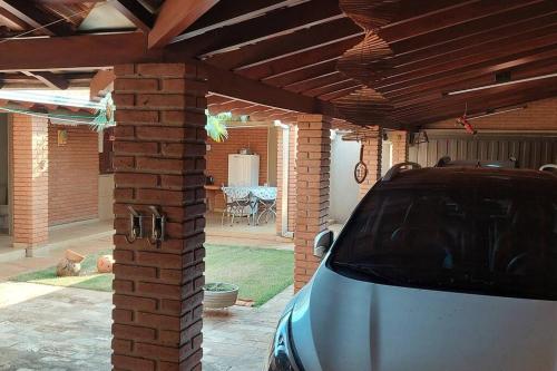 a car parked in a garage with a brick roof at Casa completa com área de lazer próxima ao centro shopping e principais vias de acesso!! in Araraquara