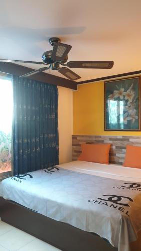 a bedroom with a bed with a ceiling fan at Casa E Mare in Kata Beach