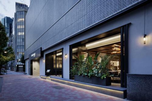 una tienda frente a un edificio con macetas en Courtyard by Marriott Tokyo Ginza Hotel, en Tokio