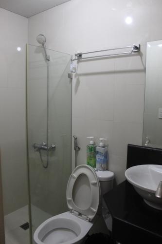 a bathroom with a shower and a toilet and a sink at Condo Palm Tree 1 Across NAIA T3 in Manila