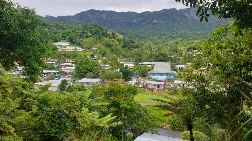 a small village in a valley with mountains in the background at New Mavida Lodge in Levuka