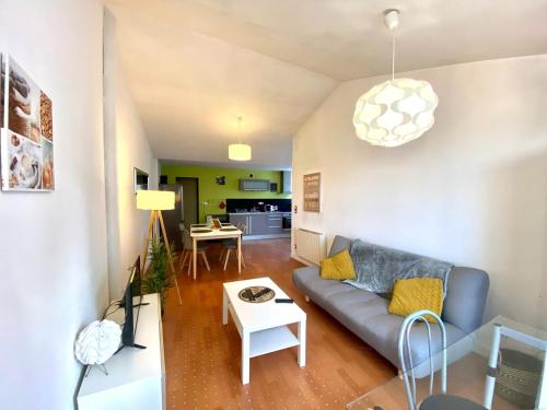 a living room with a couch and a table at Le Chêne: medieval district city centre in Poitiers