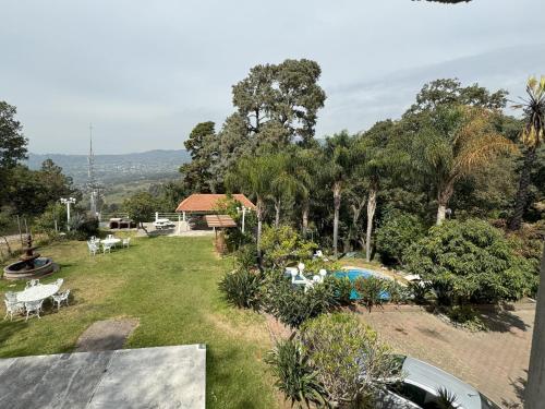 a view of a yard with a pool and trees at Hotel El Mirador y Jardin in Tlayacapan