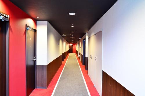 a corridor of a hospital hallway with red and white walls at Kushiro Century Castle Hotel in Kushiro