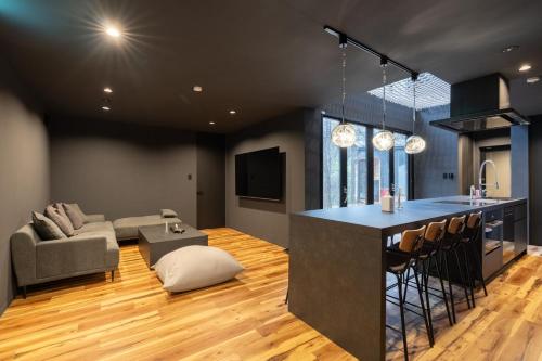 a kitchen and living room with a bar and a couch at THE SECOND Nasukogen Forest House in Nasu-yumoto