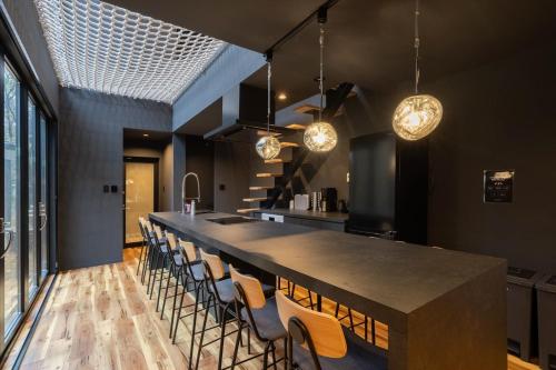 a large kitchen with a long table and chairs at THE SECOND Nasukogen Forest House in Nasu-yumoto