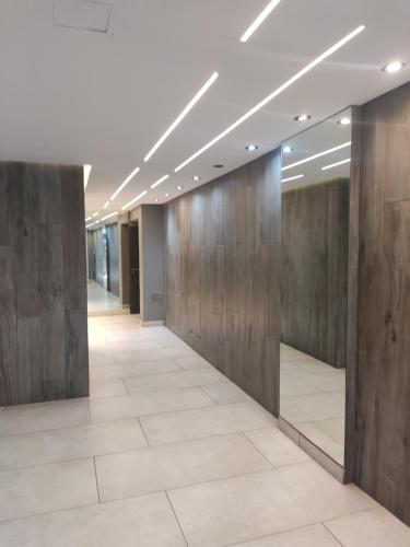 an office lobby with wood paneling and a hallway at Movistar Arena "Rincón de ensueño" Palermo in Buenos Aires